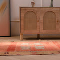 Hand-woven orange vintage Sivas Turkish wool runner rug with floral patterns in a farmhouse interior setting.