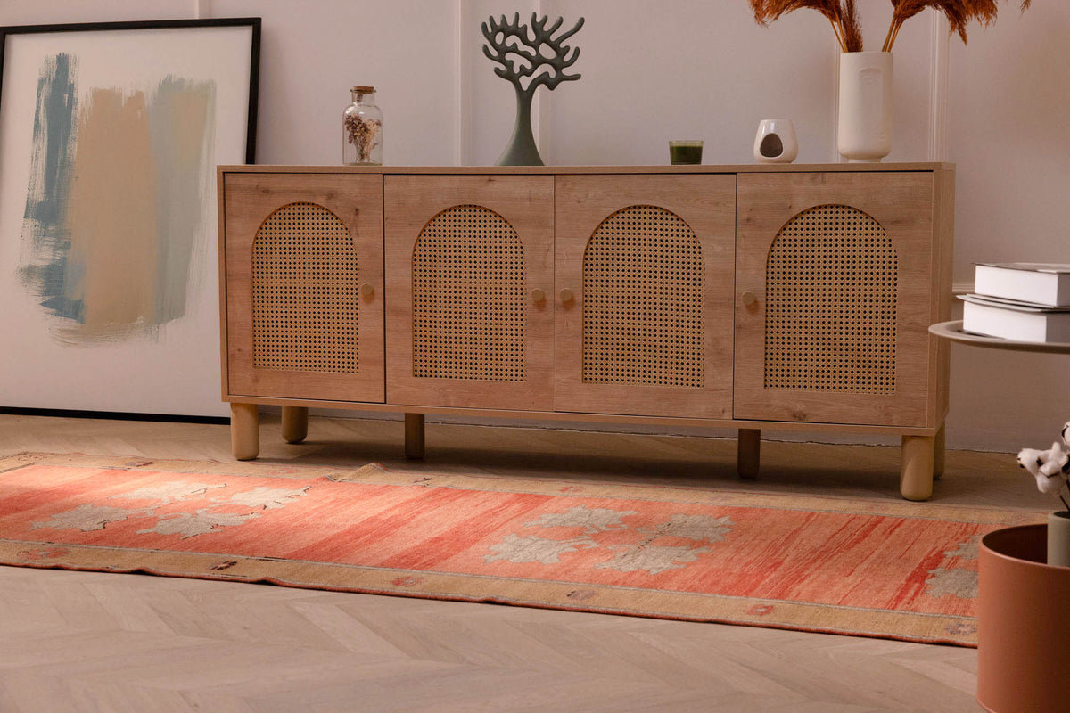Hand-woven orange vintage Sivas Turkish wool runner rug with floral patterns on a light wood floor.