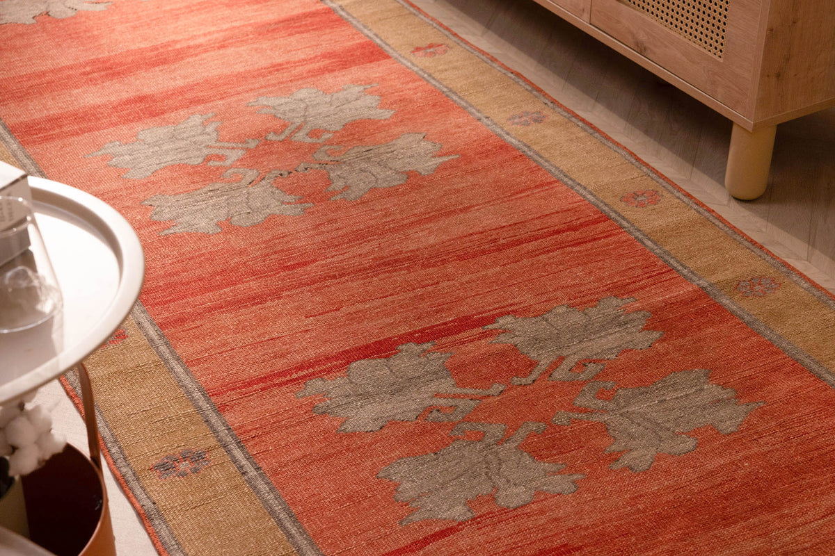 Hand-woven vintage Sivas Turkish wool runner rug in burnt orange with brown floral motifs and minimalist geometric patterns.