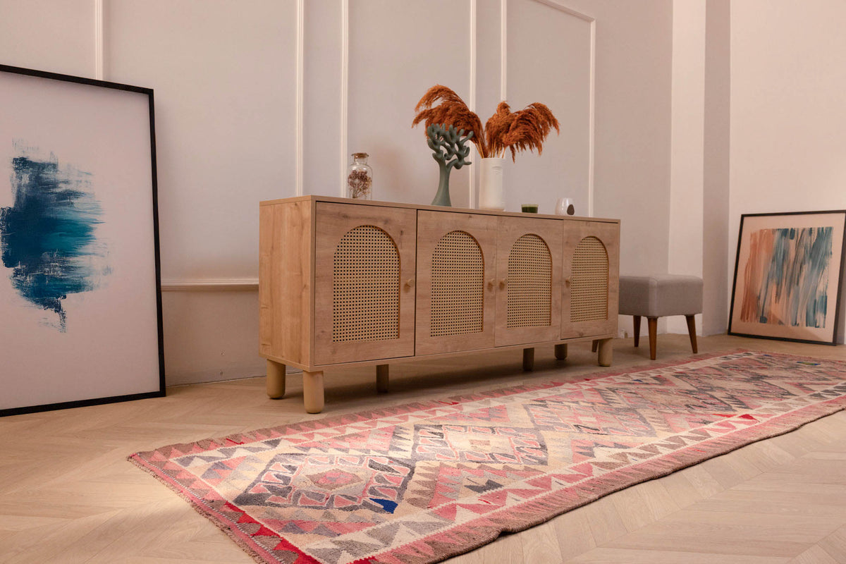 Handmade pink and gray wool-cotton Persian-style Kilim runner rug with geometric patterns in a bohemian living room.