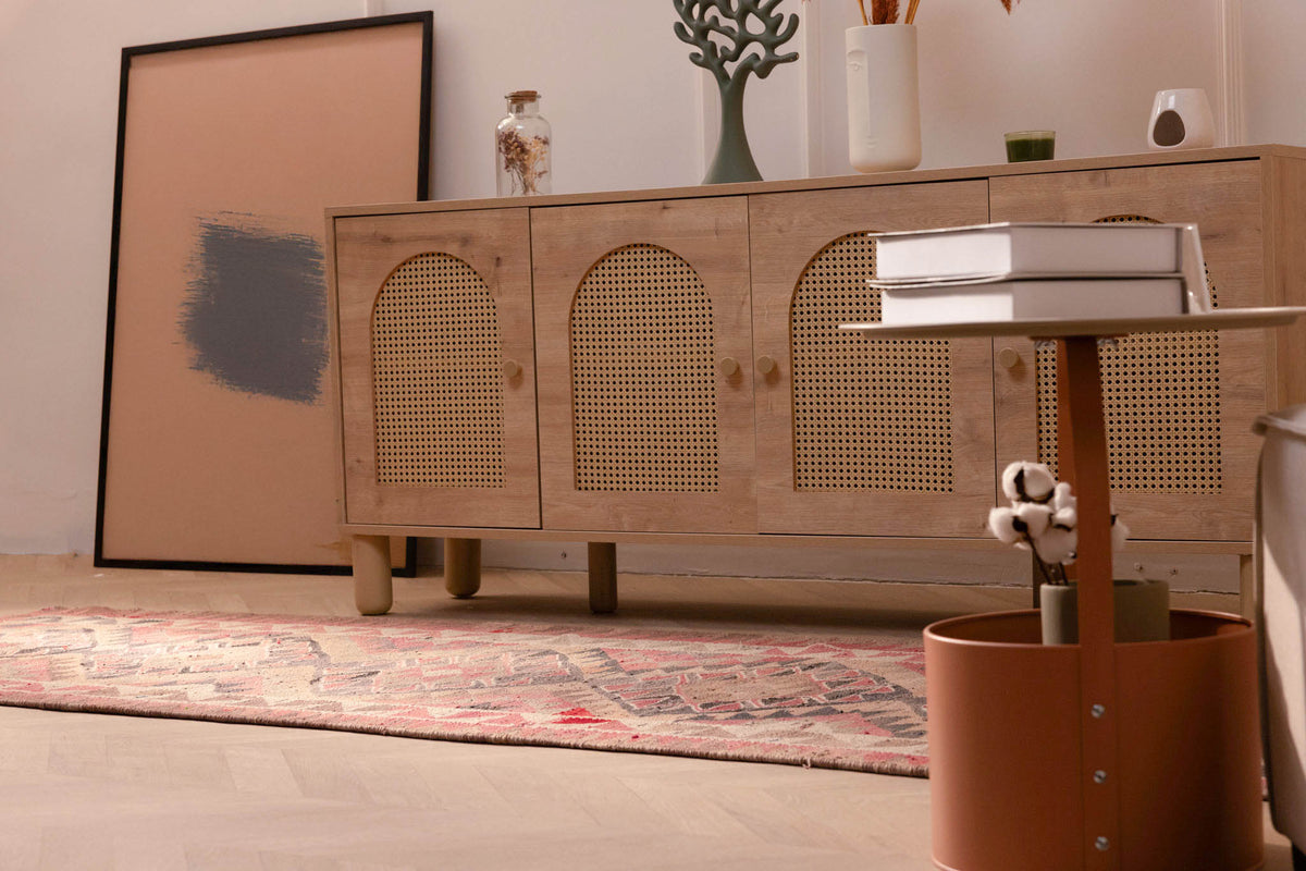 Handmade pink and gray Persian-style wool and cotton kilim runner rug with geometric patterns in a bohemian living room.