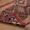 Handmade pink and gray wool-cotton Persian-style Kilim runner rug with geometric bohemian patterns.