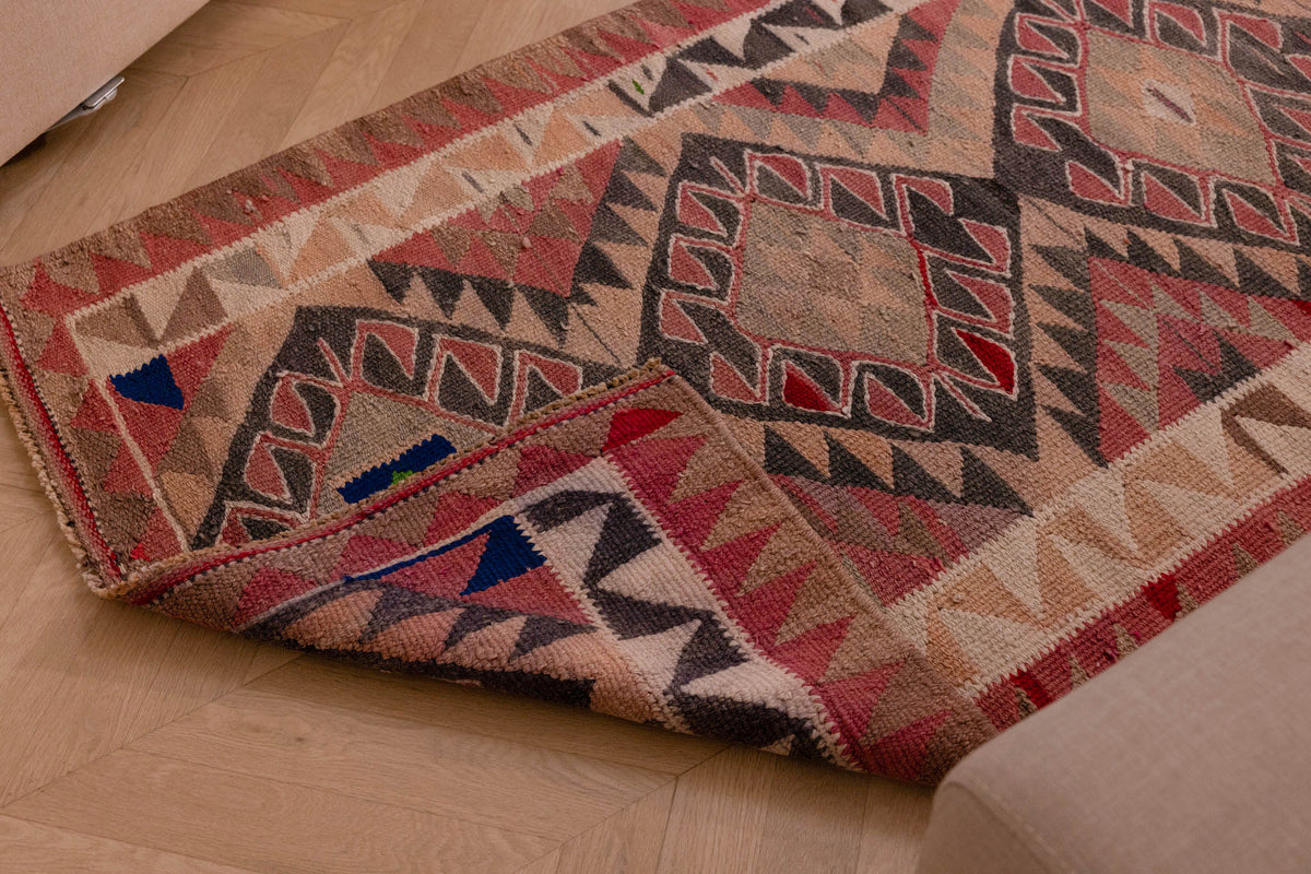 Handmade pink and gray wool-cotton Persian-style Kilim runner rug with geometric bohemian patterns.
