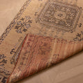 Vintage beige Konya runner rug with geometric patterns, hand-woven from wool and cotton, shown with a folded corner.
