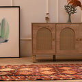 Bohemian 2.7x13.3ft wool-cotton runner rug with brown and orange geometric patterns in a modern living room.