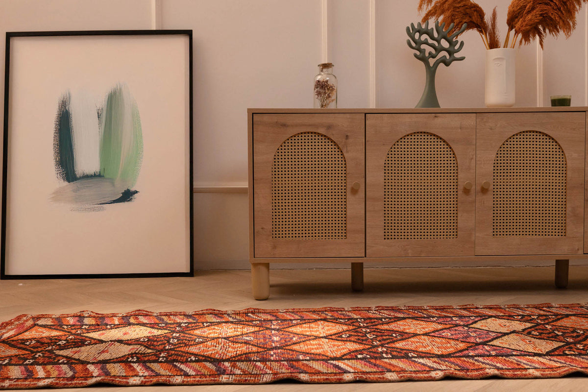 Bohemian 2.7x13.3ft wool-cotton runner rug with brown and orange geometric patterns in a modern living room.
