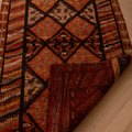 Handmade 2.7x13.3 ft wool and cotton runner rug in brown and orange with a geometric, bohemian-style maximalist pattern.