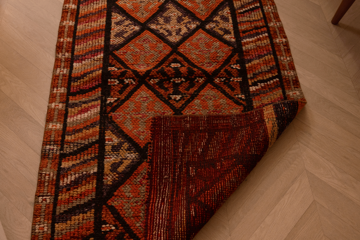 Handmade 2.7x13.3 ft wool and cotton runner rug in brown and orange with a geometric, bohemian-style maximalist pattern.