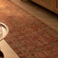 Handmade 2.7x10.9 ft wool and cotton runner rug in brown and beige with a floral bohemian maximalist pattern.