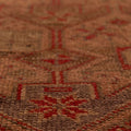 Handmade wool and cotton Persian-style runner rug in brown and beige with a floral maximalist pattern.