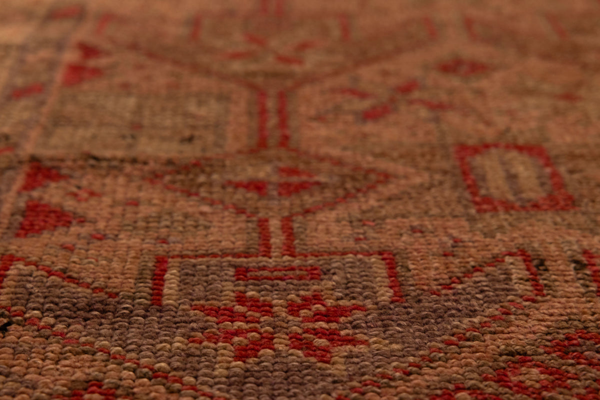 Handmade wool and cotton Persian-style runner rug in brown and beige with a floral maximalist pattern.