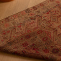 Handmade 2.7x10.9 ft wool and cotton Persian-style runner in brown and beige with maximalist floral patterns.