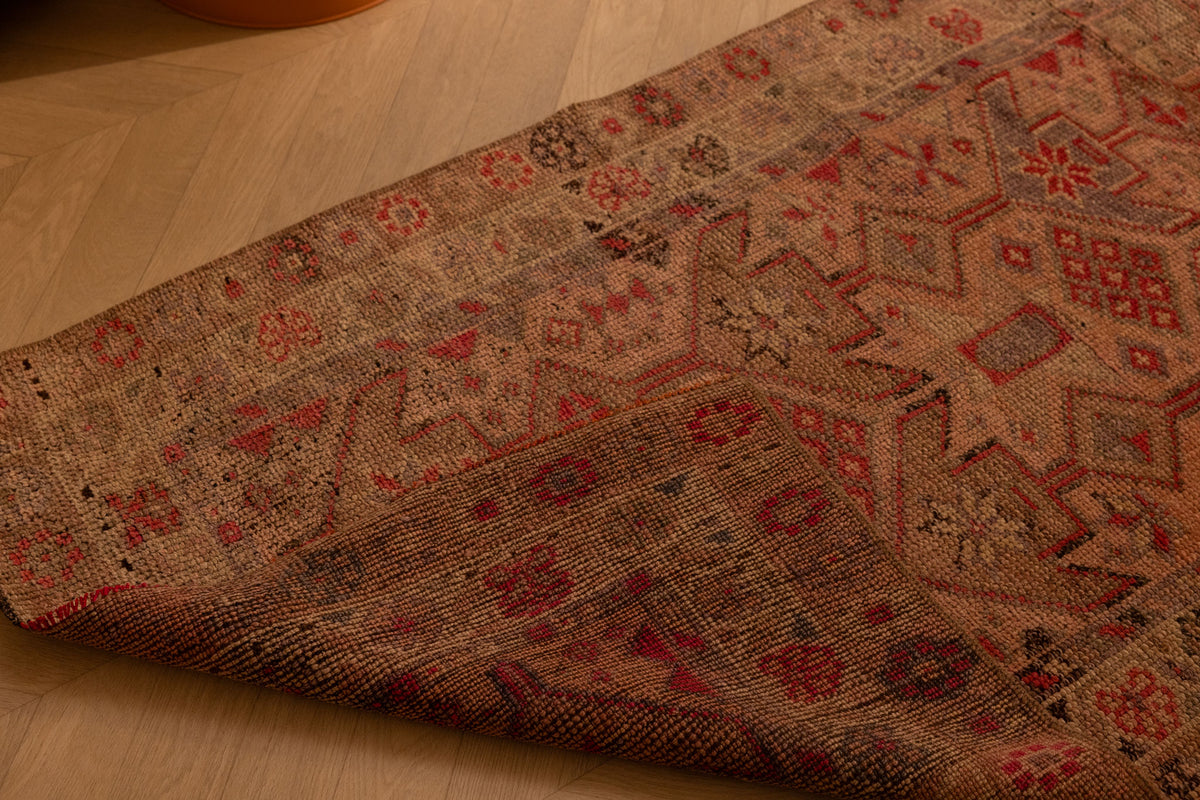 Handmade 2.7x10.9 ft wool and cotton Persian-style runner in brown and beige with maximalist floral patterns.