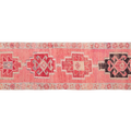 Pink patterned rug with geometric designs on a white background