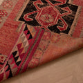 Handmade pink and black wool-cotton Persian-style runner rug with geometric bohemian patterns.