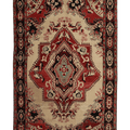 A traditional Persian-style area rug with an intricate geometric and floral pattern, featuring a central medallion and ornate borders in red, beige, black, and blue.