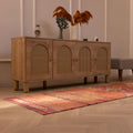Handmade 2.9x9.9 ft wool and cotton Persian-style runner rug featuring orange floral patterns in a bohemian interior.