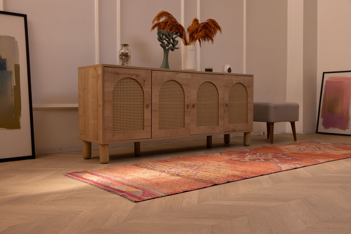 Handmade 2.9x9.9 ft wool and cotton Persian-style runner rug featuring orange floral patterns in a bohemian interior.
