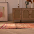 Handmade 2.9x9.9 ft wool and cotton Persian runner rug featuring orange floral patterns in a bohemian style.