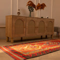 Handmade 3.2x11.2 ft Persian-style Kilim runner rug in red and orange with geometric patterns, crafted from wool and cotton.
