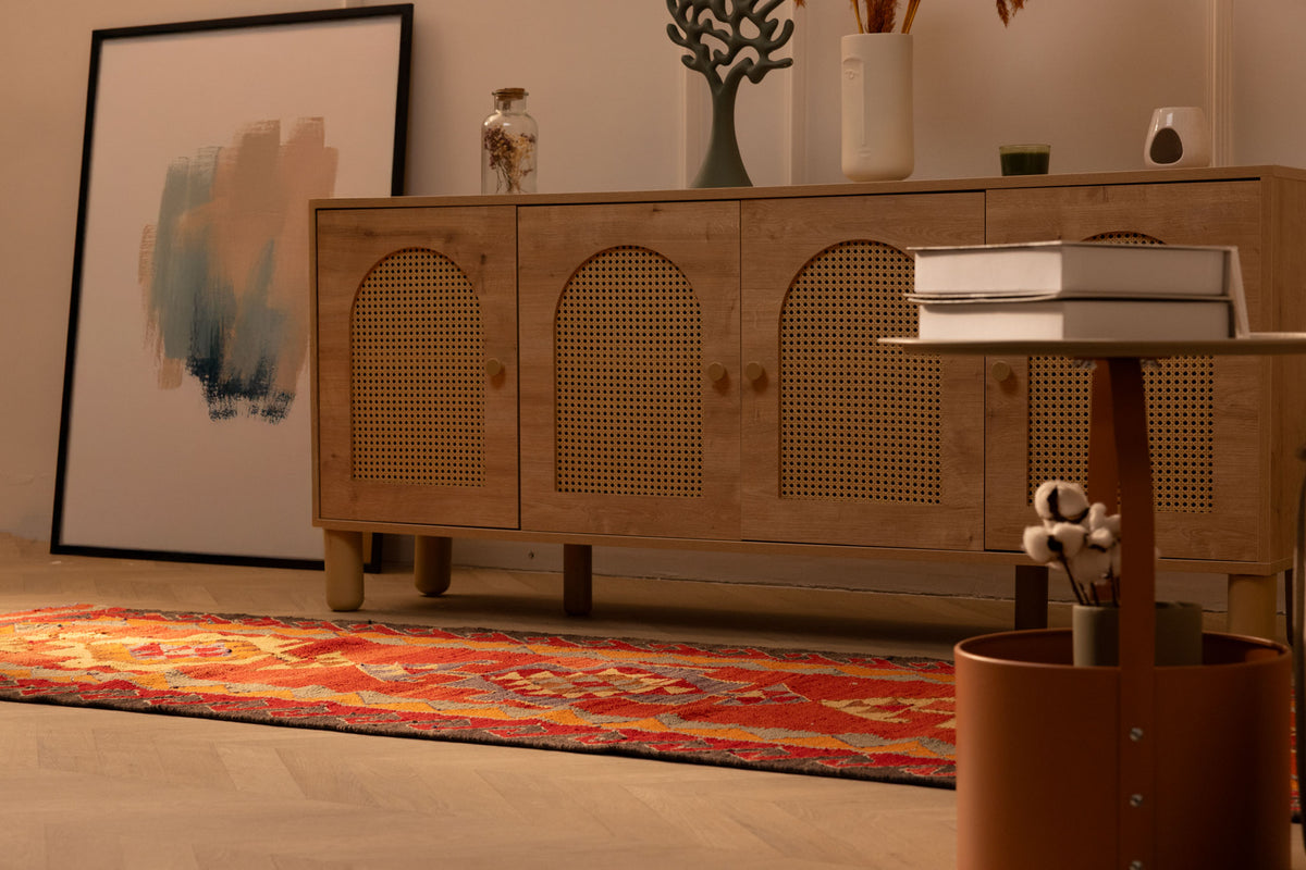 Handmade red and orange Persian-style wool-cotton Kilim runner rug with geometric patterns in a bohemian hallway.