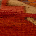 Handmade Persian-style wool and cotton Kilim runner with red and orange geometric patterns and flatweave texture.