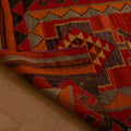 Handmade wool and cotton Persian-style Kilim runner rug in red and orange with geometric patterns on a wooden floor.