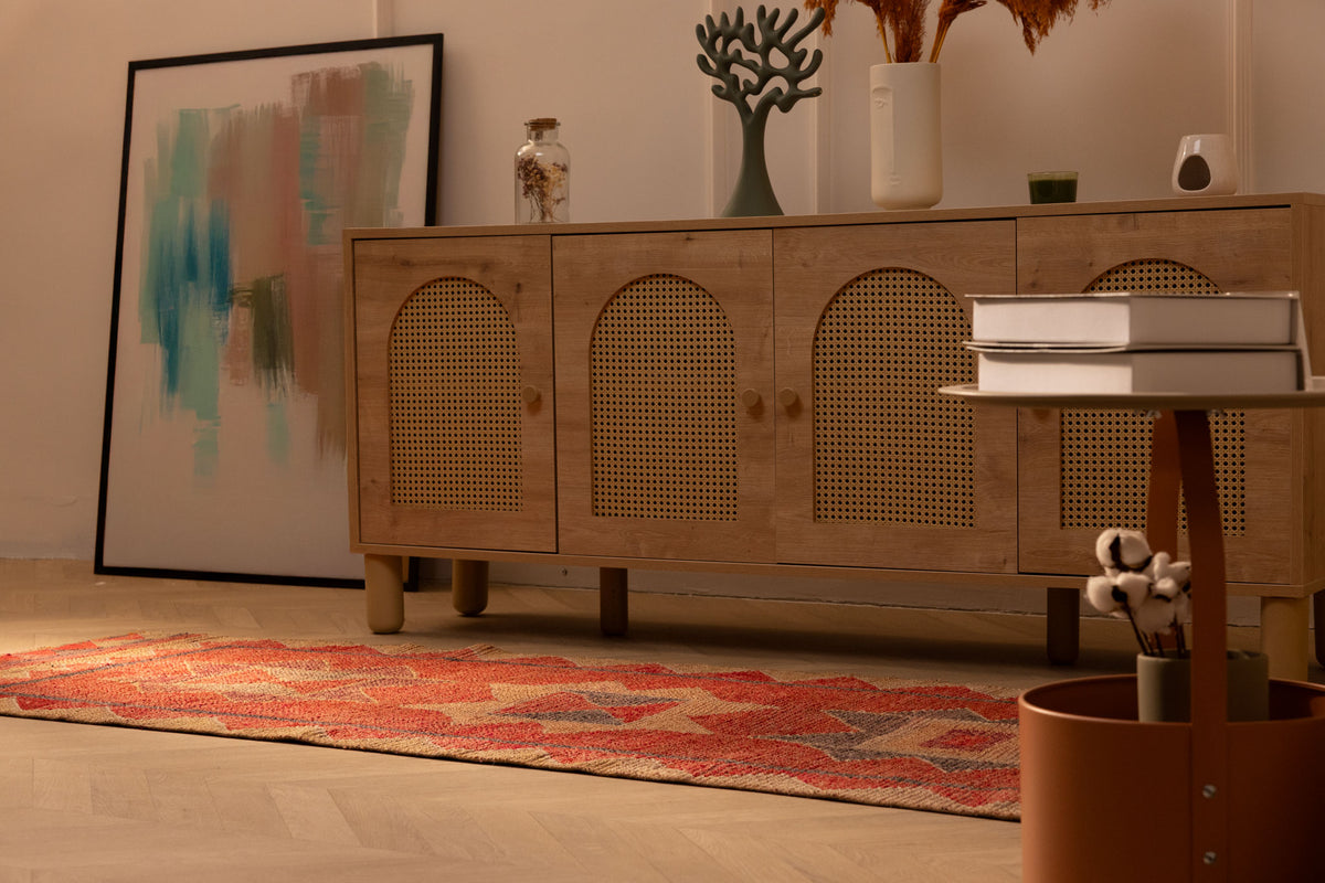 Handwoven pink and beige wool-cotton Persian runner rug with geometric patterns in a bohemian living room.