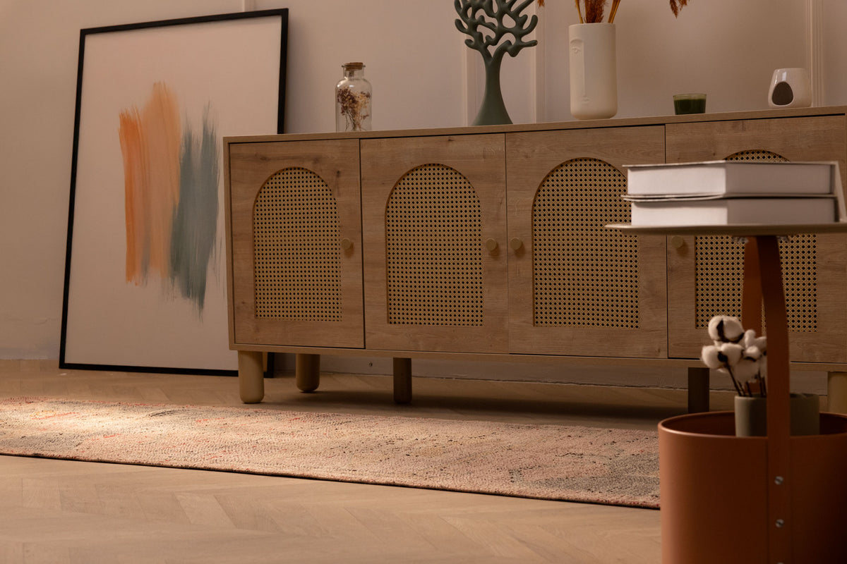 Handmade pink and brown Persian-style wool and cotton runner rug with geometric patterns on a wooden floor.