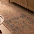 Handwoven pink and brown geometric wool-cotton runner rug in a bohemian style.