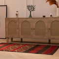 Handmade 3x5 ft vintage Turkish wool kilim rug in red and brown with geometric patterns on a light wood floor.