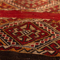 Handmade vintage Turkish wool kilim rug featuring red and brown geometric patterns in a flatweave design.