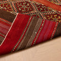 Handmade vintage Turkish wool kilim rug in red and brown with geometric patterns and a striped flatweave design.