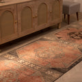 Handwoven vintage Turkish runner rug in orange and brown with geometric patterns, 3x13 ft wool and cotton blend.