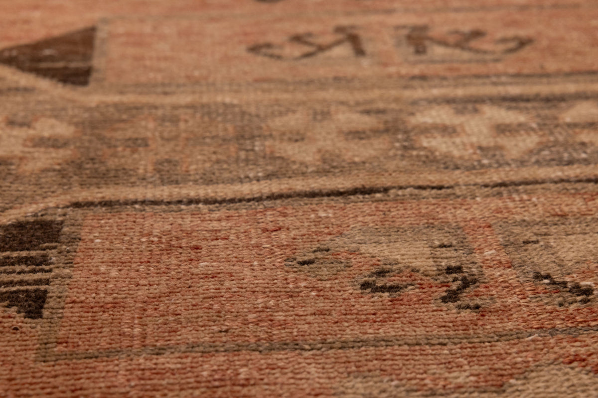 Handwoven vintage Turkish runner rug in orange and brown with geometric wool and cotton patterns.