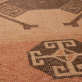 Handwoven vintage Turkish runner rug in orange and gray with geometric tribal patterns and wool-cotton texture.