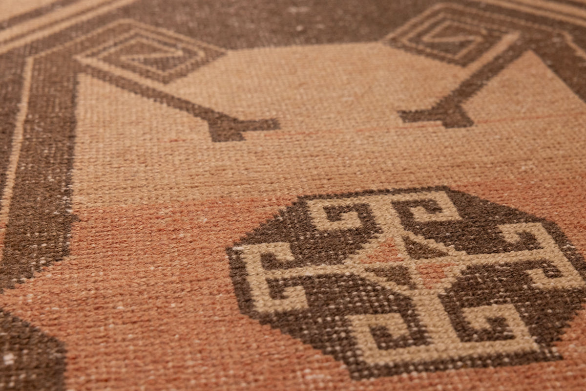 Handwoven vintage Turkish runner rug in orange and gray with geometric tribal patterns and wool-cotton texture.