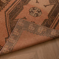 Handmade 4x14 ft vintage Turkish runner rug in orange and gray with geometric patterns, crafted from wool and cotton.