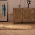 Vintage brown and beige geometric Turkish wool runner rug on a light wood floor in a farmhouse-style room.