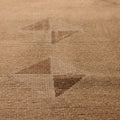 Handwoven vintage Turkish runner rug in brown and beige with geometric patterns and a textured wool-cotton blend.