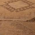 Handwoven vintage Turkish runner rug in beige and brown wool with intricate geometric patterns and low pile texture.