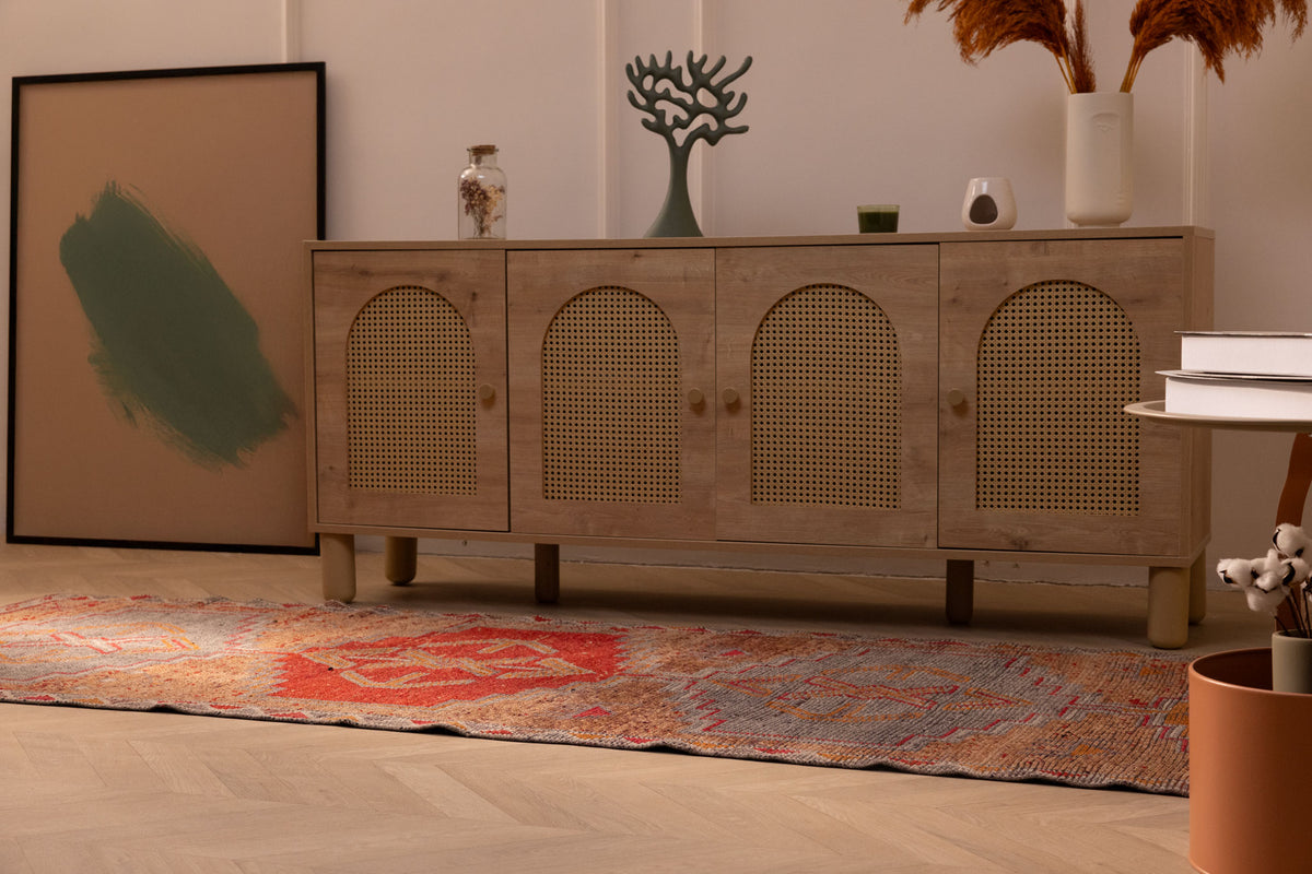 Handmade 3.4 x 10.3 ft wool and cotton Persian runner rug in orange and brown with geometric patterns on a wooden floor.