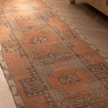 Hand-woven vintage Turkish runner rug in brown and orange with geometric patterns, 2x11 ft wool and cotton farmhouse style.