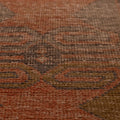 Handwoven vintage Turkish runner rug in brown and orange with geometric patterns and a textured wool-cotton blend.