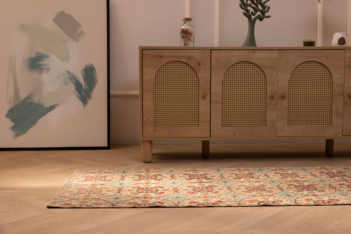 Vintage 2x8 ft Isparta Turkish runner rug in beige and sage green with floral patterns on a wooden floor.