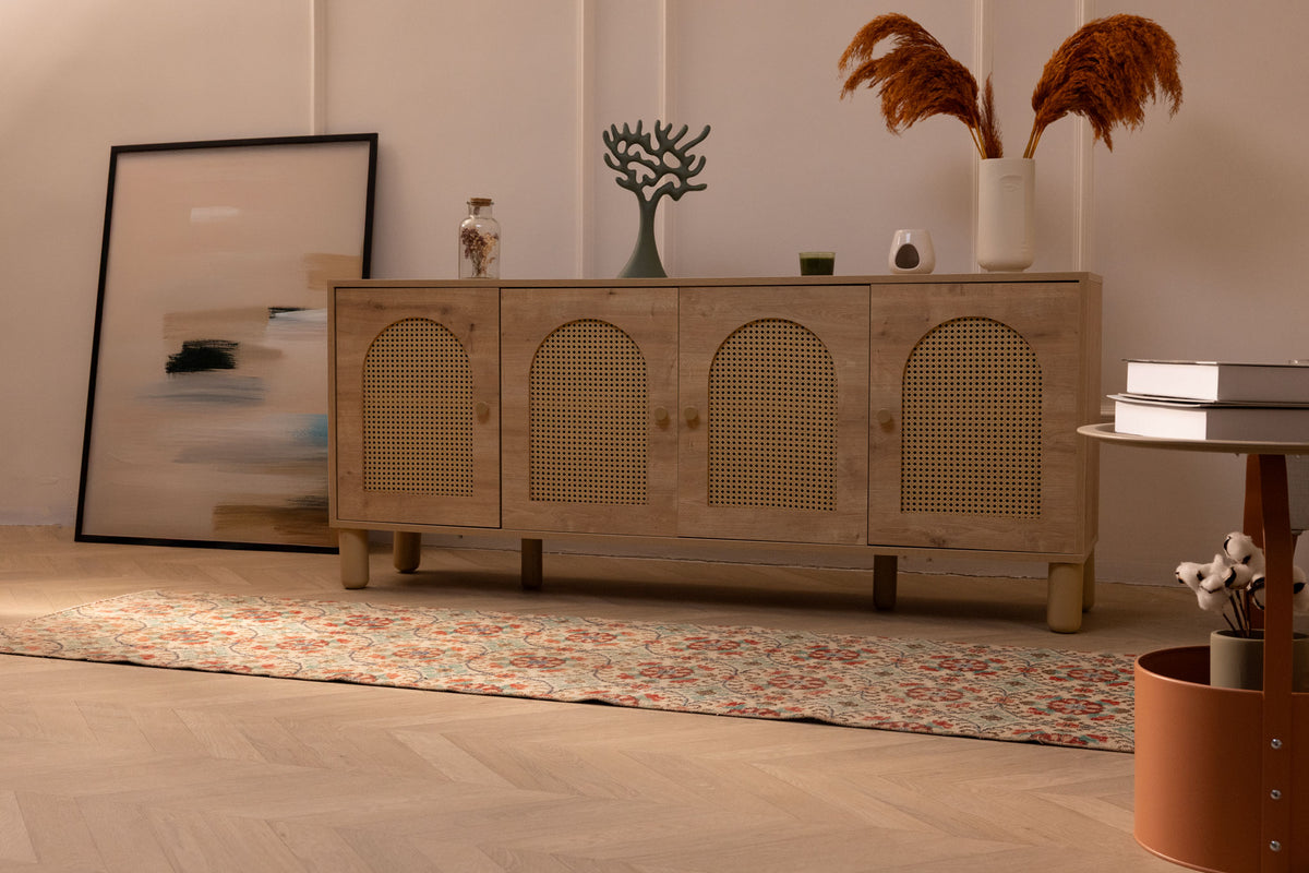 Vintage 2x8 ft Isparta Turkish runner rug with beige and green floral patterns on a wooden floor.