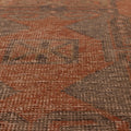 Hand-knotted vintage Turkish runner rug in burnt orange and smoky gray with geometric tribal patterns.