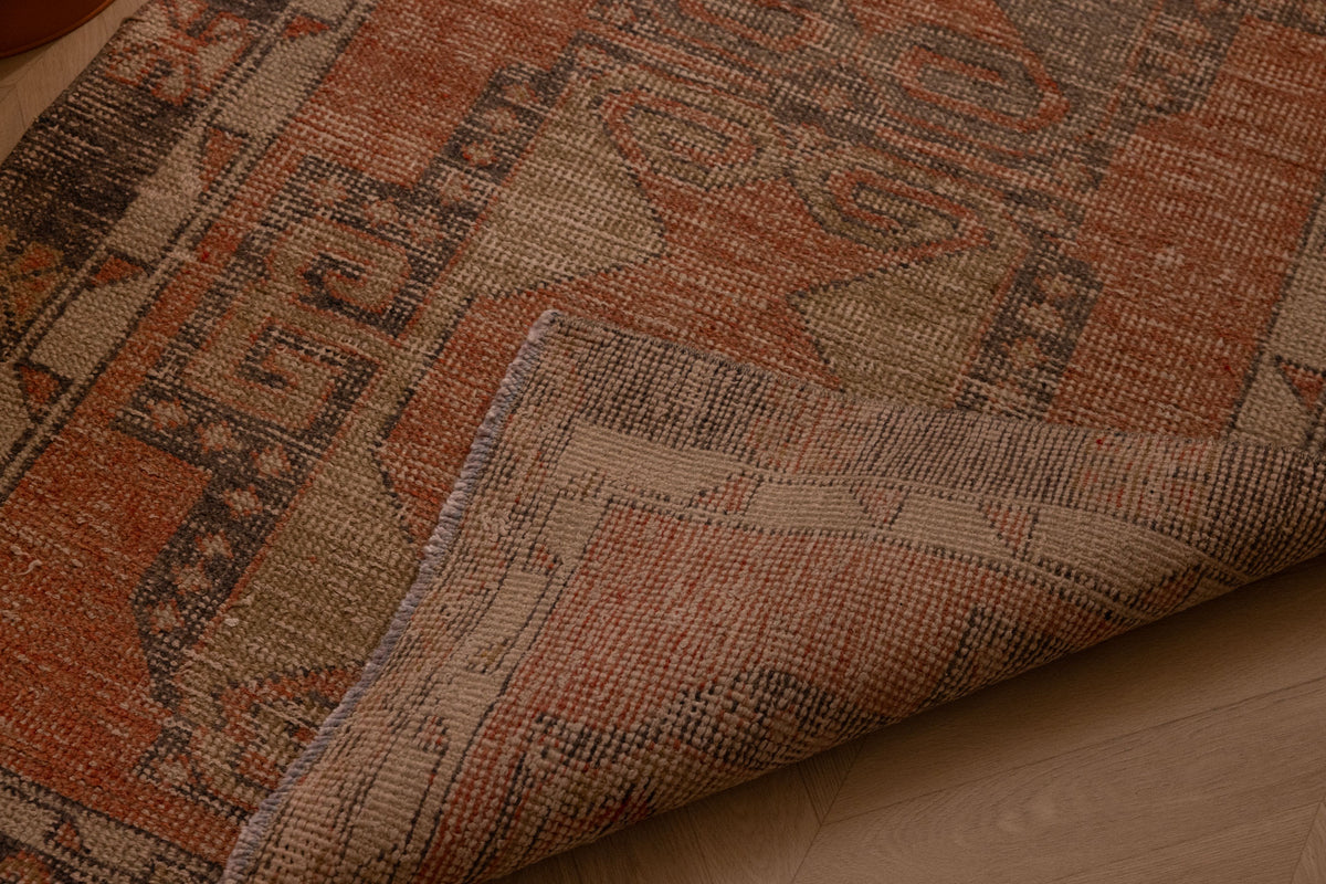 Hand-woven 3x11 ft vintage Turkish runner rug in orange and gray wool with geometric tribal patterns.