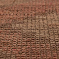Close-up of a handmade pink and beige wool-cotton Persian style runner rug with a textured low-pile geometric pattern.