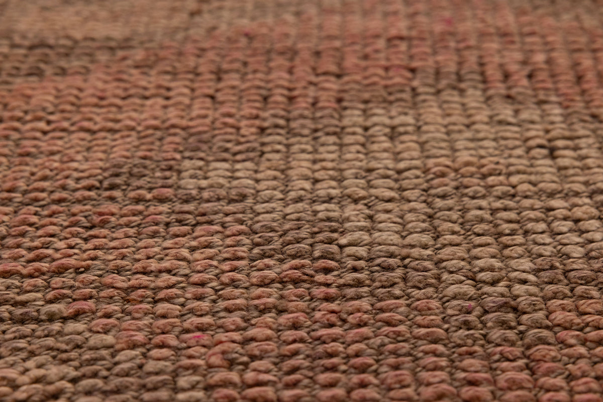 Close-up of a handmade pink and beige wool-cotton Persian style runner rug with a textured low-pile geometric pattern.